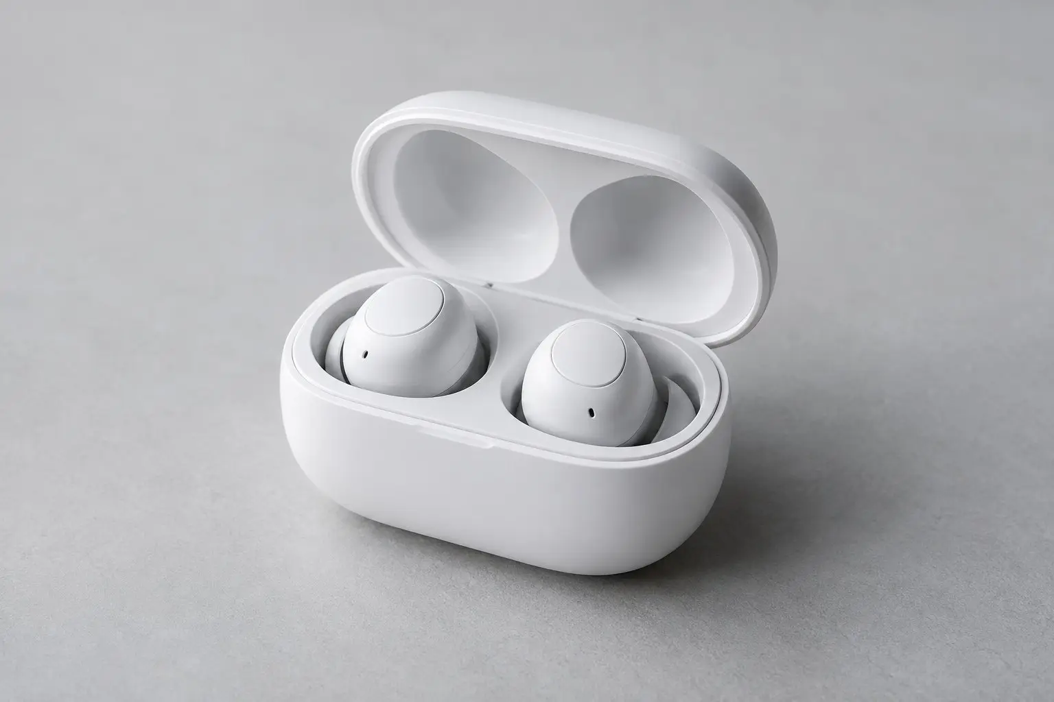Generic wireless earbuds in an open charging case on a light surface